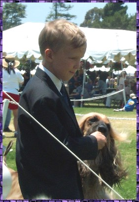 Richard shares a cookie with Samson Sings Hosanna, an Afghan Hound, at Long Beach Kennel Club, CA - AKC dog show