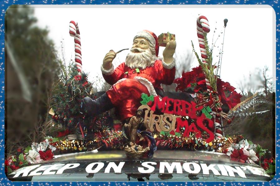 close up photograph of Santa Clause and his pipe, on the roof of the Liberty Van KEEP ON SMOKING